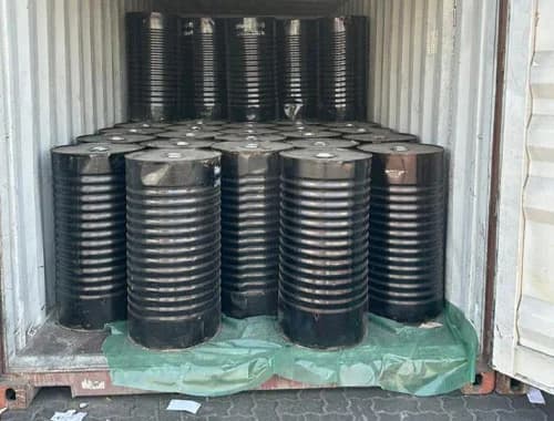 Bitumen drums stowed in a container.