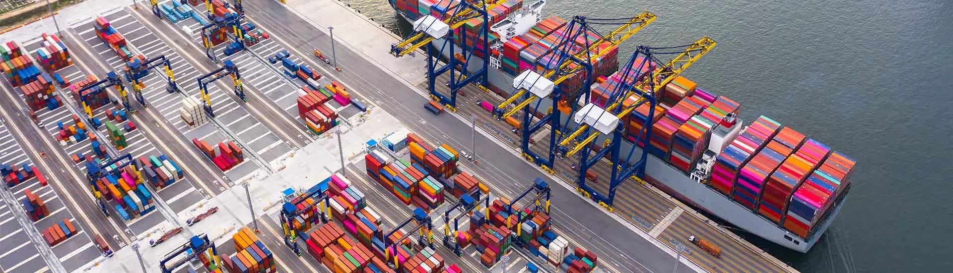 Aerial view of a container terminal with a vessel alongside.