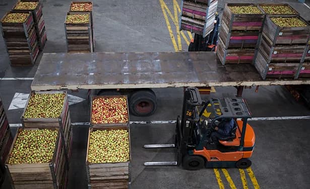 A forklift moving crates across a warehouse floor.